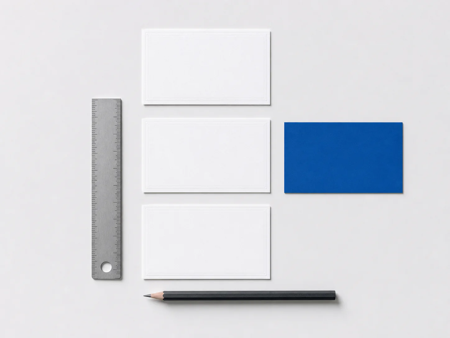White and cobalt product planning cards arranged beside a ruler and pencil